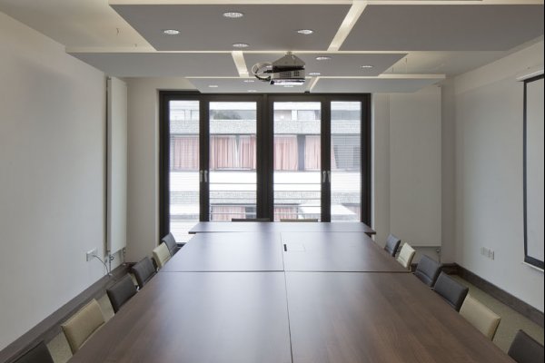Seminar Room 1, in boardroom layout, facing two full-length windows