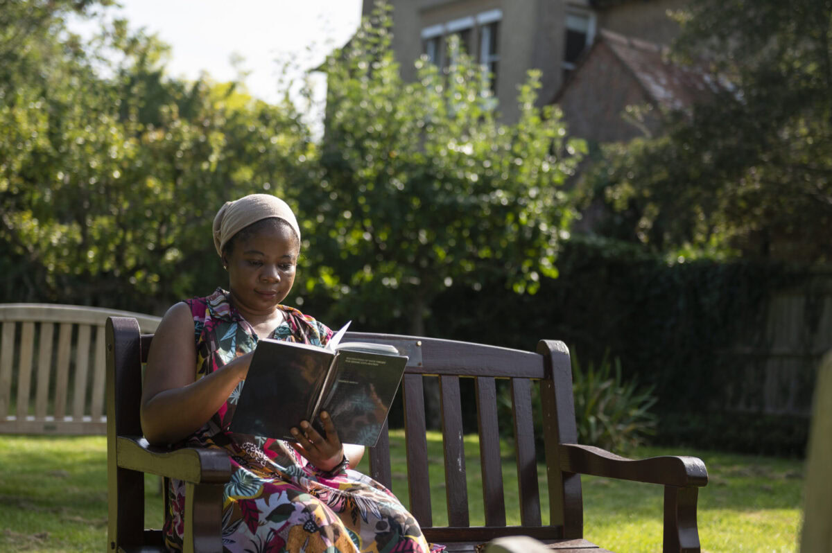 A student reading in the Bishop's Garden