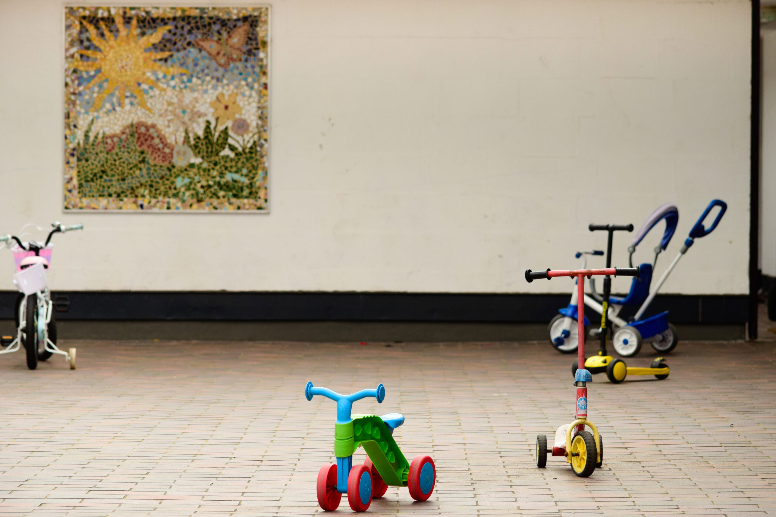 The family courtyard at Wolfson, with a tricycle in the foreground.