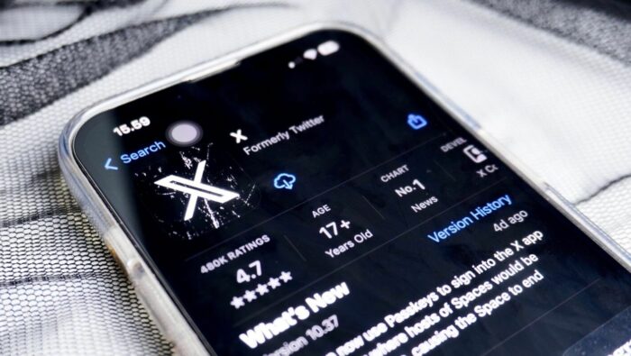 Close-up of a smartphone screen displaying the X app (formerly Twitter) in the App Store, showing a 4.7-star rating and the tagline “No. 1 in News.”