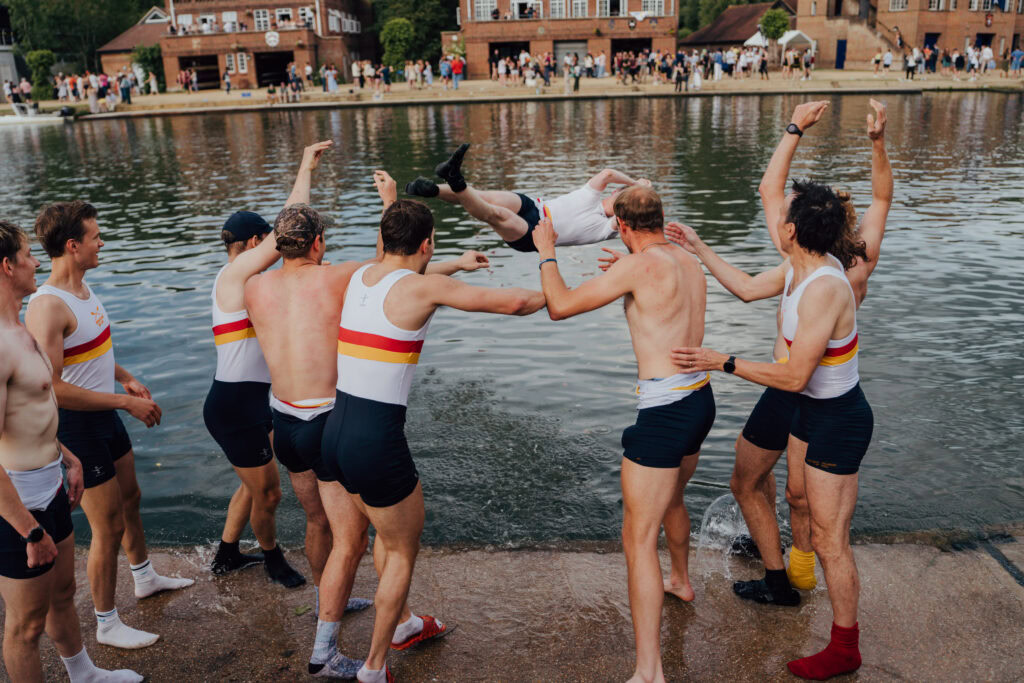 Wolfson M1 rowers throw their cox into the river in celebration, continuing the traditional victory ritual after a historic Summer Eights win.